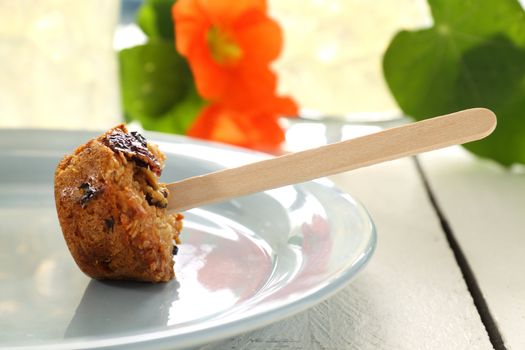 Fresh baked cake or muesli pop on a stick ready to eat.