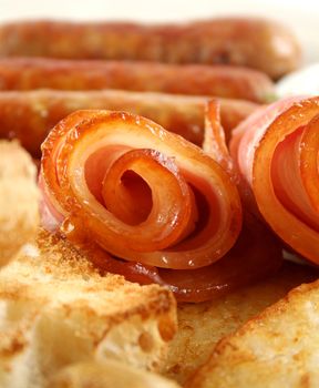 Crispy rolled bacon with toast and sausages.