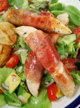 Chicken tenderloins wrapped in prosciutto with oven roasted chat potatoes and a garden salad.
