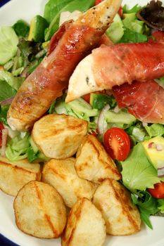 Chicken tenderloins wrapped in prosciutto with oven roasted chat potatoes and a garden salad.
