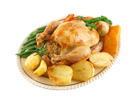 Whole roast chicken with potatoes pumkin carrots and beans.