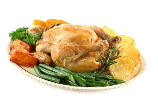 Whole roast chicken with potatoes pumpkin carrots and beans.