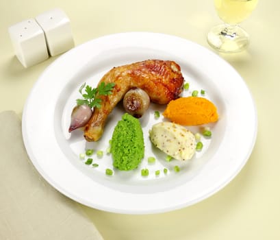 Baked chicken quarter with mashed peas, pumpkin and potato with onions.