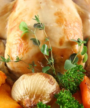 Whole roast chicken with potatoes pumpkin and carrots.