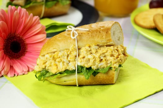 Freshly prepared curried egg and lettuce roll.