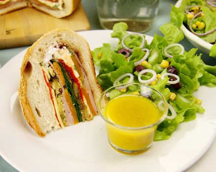 Delicious savory cob loaf filled with ham, salami, aubergine, cottage cheese and vegetables with a corn salad.