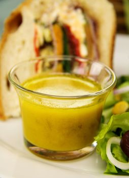 Delicious and spicy mustard dressing served with a slice of savory loaf.