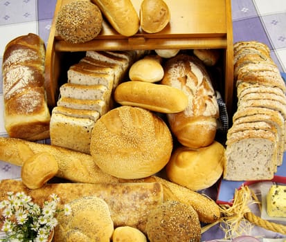 Selection of different types of rolls, loaves and bread sticks.