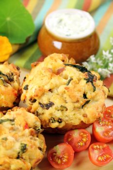 Fresh baked savory muffins with herb spread and cherry tomatoes.