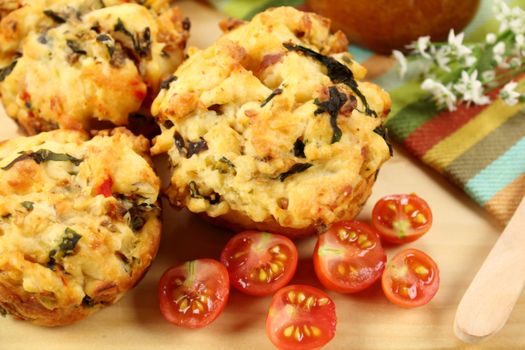 Fresh baked savory muffins with cherry tomatoes ready to serve for breakfast.