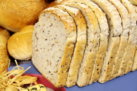 Close up sliced bread with selected breads in the background.