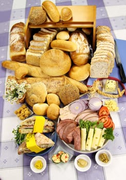 Selection of different breads with ingredients for making sandwichws.