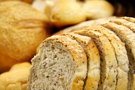 Close up sliced bread with selected breads in the background.