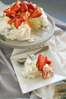 A sliced serving of strawberry pavlova ready to go to the table.