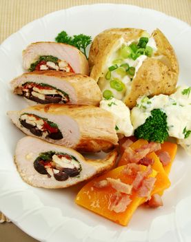 Chicken stuffed with a Mediterranean filling made of spinach, fetta, peppers and olives with vegetables.