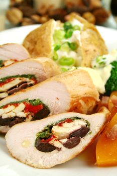 Chicken stuffed with a Mediterranean filling made of spinach, fetta, peppers and olives with vegetables.