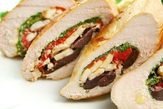 Chicken stuffed with a Mediterranean filling made of spinach, fetta, peppers and olives with vegetables.