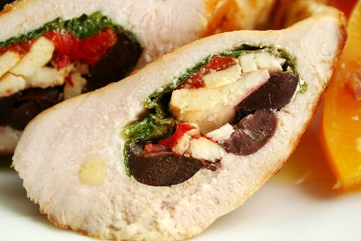 Chicken stuffed with a Mediterranean filling made of spinach, fetta, peppers and olives with vegetables.