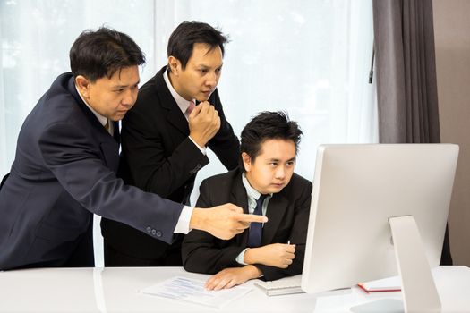 Team of businessmen analysis their business with computer desktop