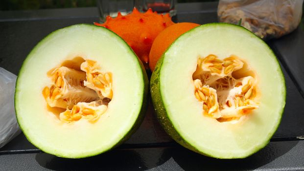 Exotic fruits: melon, kiwano and orange
