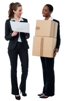 Smiling businesswomen discussing stock details