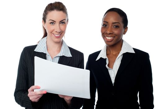 Female executives with financial document