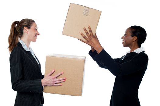 Businesswoman passing packed cartons