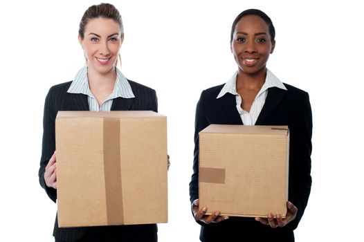 Female executives holding cardboard boxes