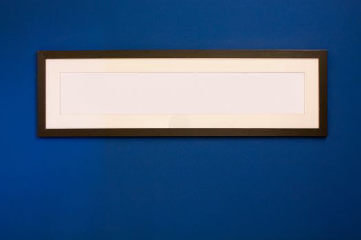 Long Wooden Frame on blue wall.