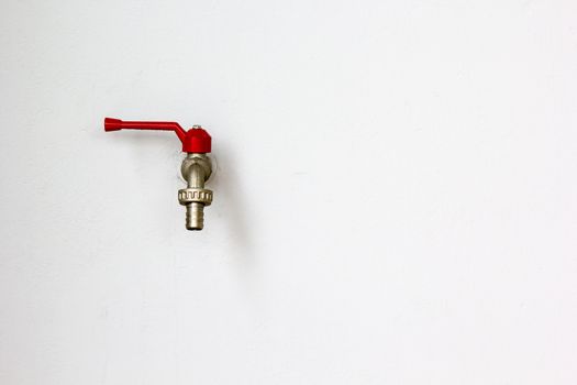 Closeup faucet on concrete white wall background
