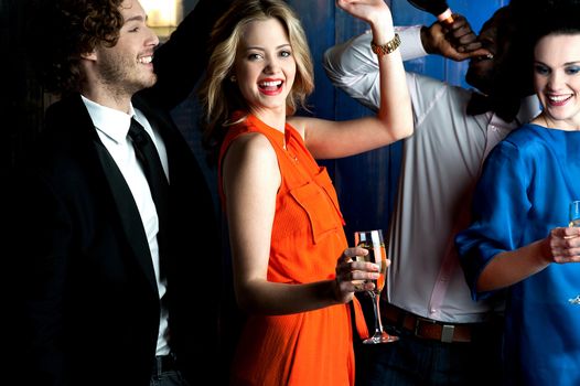 Young couples drinking and dancing in a club.