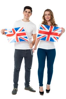 Young couple holding UK flag with pride