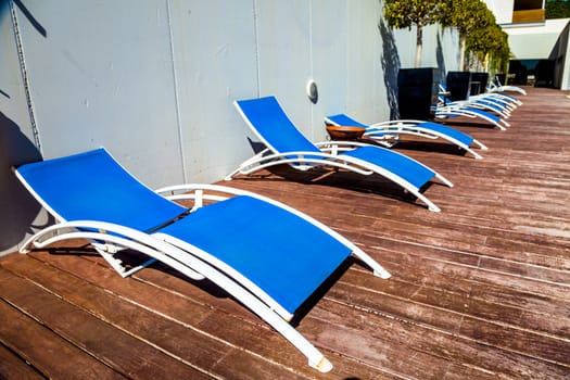 Several deckchairs near the swimming pool