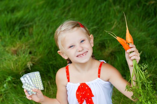 small girl with medicine and carrots