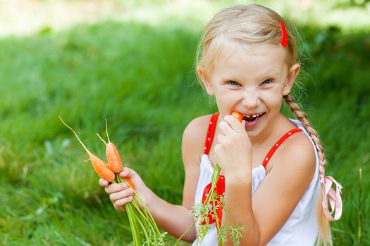 small girl eating carrots