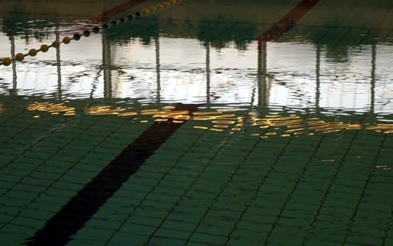 Reflection on surface of swimming pool prior to competition