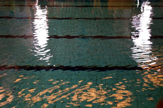 Sunlight and natural light reflect of surface and bottom of swimming pool