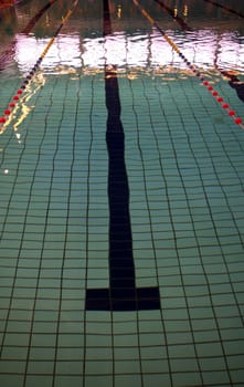 Lane of a swimming pool with sunlight reflecting off surface