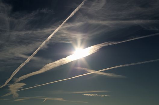 Sun illuminates aircraft contrails