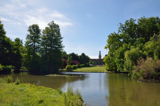 City park in Milan with lake and Sforza castle behind