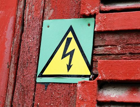 danger high voltage sign on red rusty door