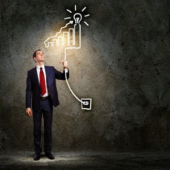 Image of businessman in black suit against dark background