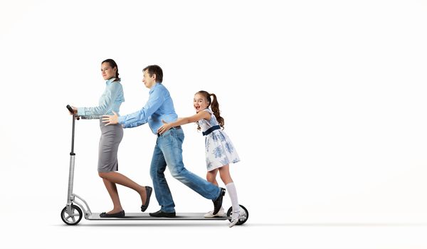 Image of happy young family riding scooter