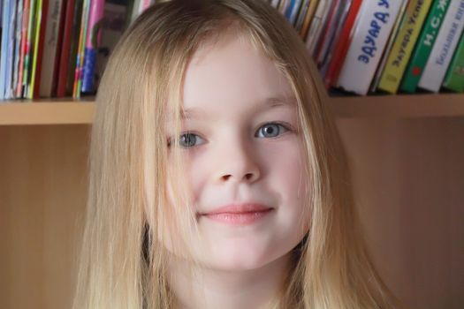 Portrait of beautiful girl on book background