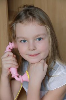 Portrait of beautiful girl with pink telephone