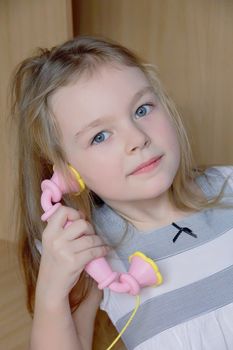 Portrait of beautiful girl with pink telephone