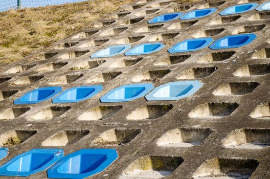 cement slope surface mounted plastic blue chairs four row