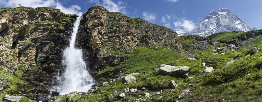 waterfall in the foreground and Mount Matterhorn in the background