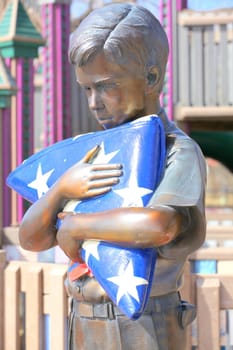 Boy scout statue displayed outdoors.