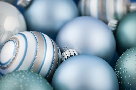 Close up of several blue Christmas glass baubles
